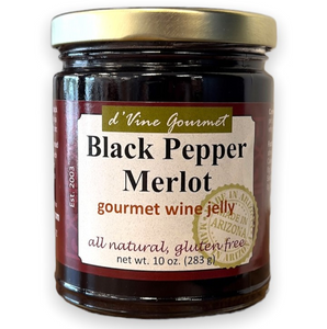 Round glass jar with gold lid containing purple jelly.