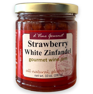 Round glass jar with gold lid containing red colored jelly.