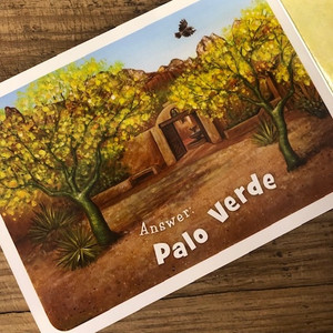 Open page of book with picture of trees and white lettering