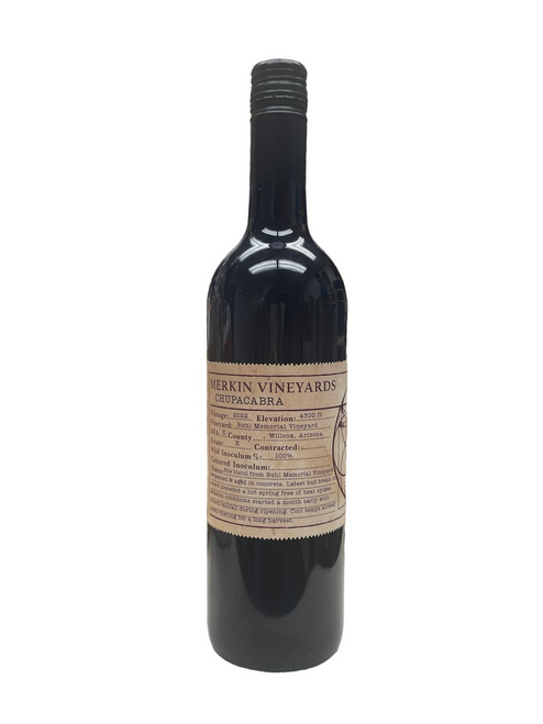 Tall dark glass wine bottle with light brown front label