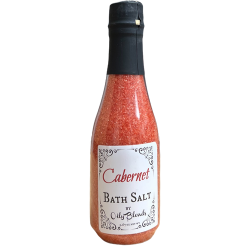wine bottle shaped, plastic bottle containing red colored bath salts and a white front label