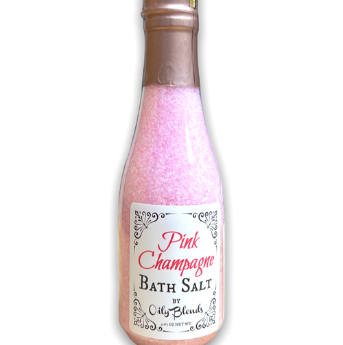 wine bottle shaped clear plastic bottle containing pink bath salts with a white front label