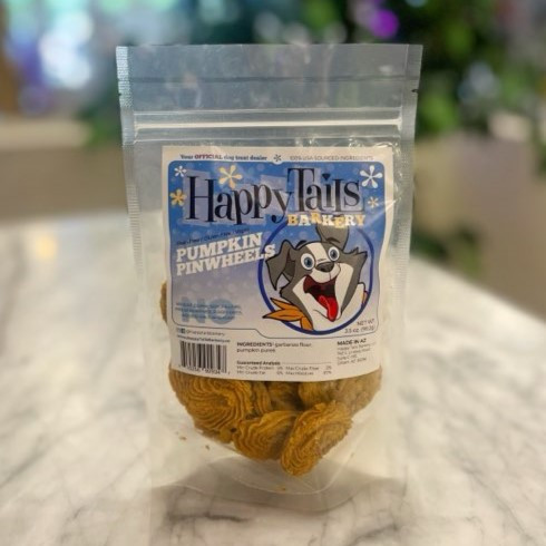 Clear plastic resealable food pouch showing contents of light brown dog treats with blue and white front label