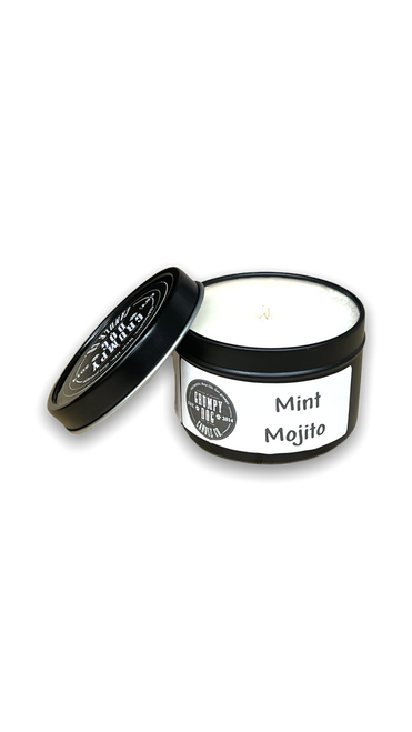 round black metal tin with lid containing white candle wax
