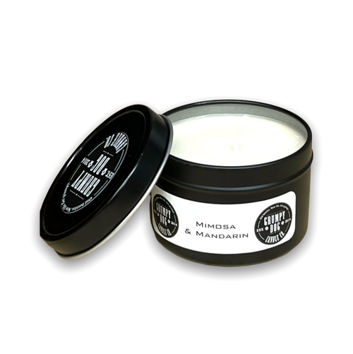 round black metal tin with lid containing white candle wax