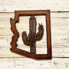 rusted steel in the outline shape of Arizona and a saguaro cactus in the center.