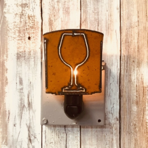 Rustic iron night light with cut out in the shape of a wine glass.