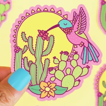 A yellow sun behind flowering cacti and a graceful hummingbird