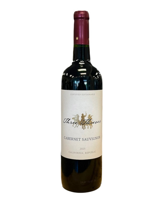 Dark glass wine bottle with off white label and black lettering with silhouette of three cowboys 