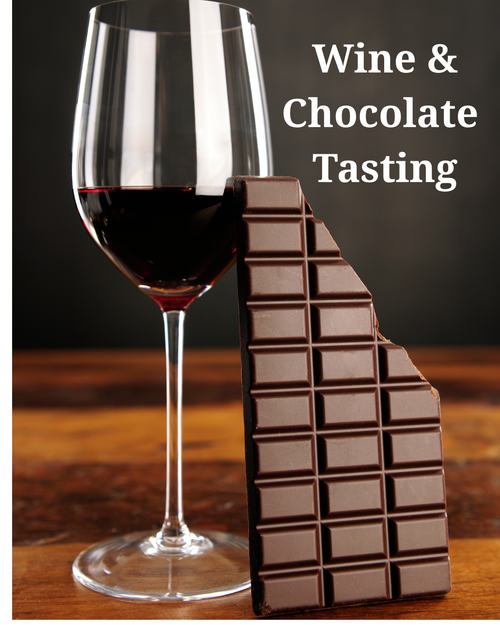 Picture of glass of red wine and bar of chocolate on a wood table