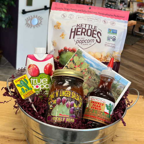 Gift basket items displayed in a round tin bucket. All contents of basket listed in the product description.