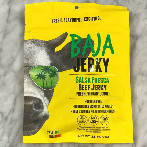 yellow pouch with a large picture of half of a cows face on the left side; the cow is wearing sunglasses with the reflection of green palm trees. "Baja Jerky" is written boldly across the top, above the product information yellow pouch with a large picture of half of a cows face on the left side; the cow is wearing sunglasses with the reflection of green palm trees. "Baja Jerky" is written boldly across the top, above the product information