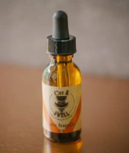 amber bottle with a black dripper type top