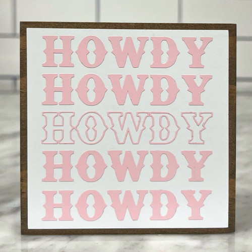 Square wood block with white background and the word Howdy in pink lettering listed five time