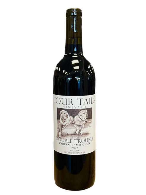 Dark glass wine bottle with light tan front label with image of two lab dogs