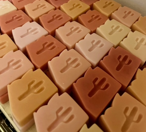 Rows of bar soap in the shape of Arizona in shades of tan and brown