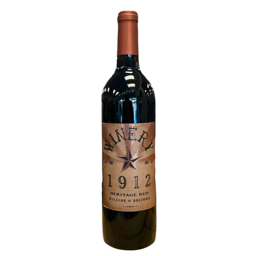 Wine bottle with Winery 1912 front label in tones of copper and black. 