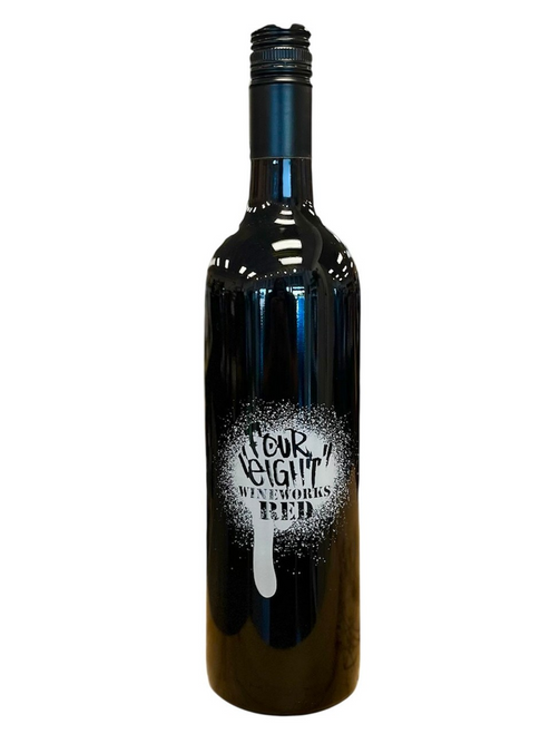 Tall dark glass wine bottle. Front label looks spray painted in white