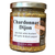 round clear glass jar with gold lid containing whole grain mustard