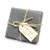 Stack of black slate coasters tied together with twine and a light tan tag
