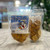 Clear plastic resealable food pouch showing contents of light brown dog treats with blue and white front label