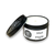 Candle in a round black tin with lid and white label with black lettering