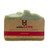 Light green bar of soap with tan paper wrapping for a label with dark pink writing