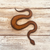 Rustic iron magnet in the shape of a snake.