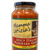 Tall clear glass jar with black lid containing red pasta sauce with tan label.