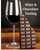 Picture of glass of red wine and bar of chocolate on a wood table