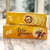 Two stacked yellow long, rectangular box with image of crackers and lettering in black
