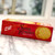 Red long, rectangular box with image of crackers and lettering in black
