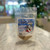 Clear plastic resealable food pouch showing contents of light brown dog treats with blue and white front label