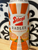 beer can with orange stripe and red lettering