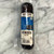 Sausage in clear packaging with blue and light tan front label displayed on marble counter.