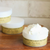 White round plastic tub displaying white cream with a tan label