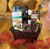 Rectangular metal container displaying contents of gift