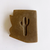 dark brown bar of soap in the shape of Arizona with a cut out shape of a saguaro cactus in the middle
