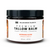 Dark plastic round jar with front label in white and orange with black and orange lettering