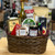 Brown oval wicker basket filled with brown crinkle paper and snacks. See product description for full details of what items are included.