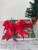 Wrapped gift box with a bow in front of a Christmas tree. Wrapped gift box with a bow in front of a Christmas tree.