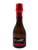 black glass wine bottle with black and red label and red foil