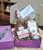 Gift contents displayed in a purple gift box with a "thank you" card on the top cover.  Full list of gift contents listed in product description.