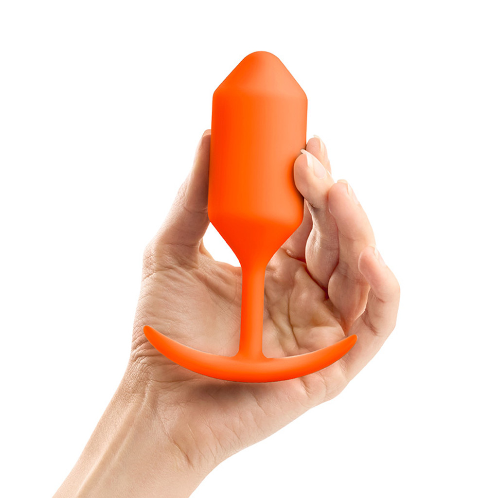 Orange b-Vibe Snug Plug 3 Weighted Silicone Plug - Hand