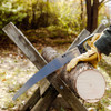 A gloved hand cutting a log on a sawbuck with the Super Duty D-Handle Saw