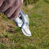 Close-up of a hand gripping the Pro Series Forged Bypass Pruner in a vineyard