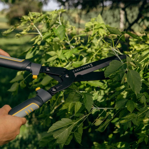 The Super Duty MaxForce Hedge Shears trimming leafy green growth