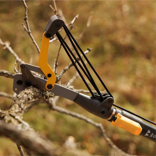 The Heavy Duty Tree Pruner cutting head hooked over a bare branch
