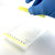 Peeling PCRSEAL-SF standard PCR sealing film from 96-well plate with gloved hand