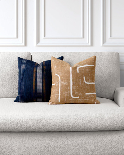 Caramel Pillow Package styled on a neutral indoor sofa | Instinct Caramel and Journey Indigo